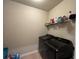 Well-organized laundry room with modern washer and dryer, plus storage shelving at 3566 Andover Way, Buford, GA 30519