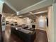 Large living room with coffered ceiling, fireplace, large sectional sofa and hardwood floors at 3566 Andover Way, Buford, GA 30519