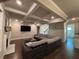 Comfortable living room with coffered ceilings, fireplace, large sectional sofa and hardwood floors at 3566 Andover Way, Buford, GA 30519