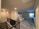 Upstairs loft area with large sectional sofa and ceiling fan. View from top of staircase at 3566 Andover Way, Buford, GA 30519