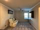 Upstairs loft area with sectional sofa, ceiling fan and mounted tv at 3566 Andover Way, Buford, GA 30519