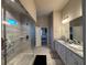 Modern main bathroom with double sinks, granite countertops, and a glass-enclosed shower at 3566 Andover Way, Buford, GA 30519