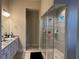 Modern main bathroom featuring double sinks, granite countertops, and a glass-enclosed shower at 3566 Andover Way, Buford, GA 30519