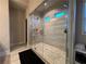 Bright modern shower featuring a shower head, hand wand, tile, and shower seat at 3566 Andover Way, Buford, GA 30519