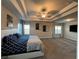 Spacious main bedroom with tray ceiling, carpeted floors and two windows at 3566 Andover Way, Buford, GA 30519