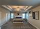 Spacious main bedroom with tray ceiling, carpeted floors and two windows at 3566 Andover Way, Buford, GA 30519