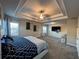 Spacious main bedroom with trey ceiling, ceiling fan, carpet and two large windows at 3566 Andover Way, Buford, GA 30519