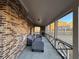 Covered patio featuring brick exterior, screened windows, and comfortable seating area at 3566 Andover Way, Buford, GA 30519