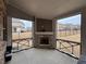 Screened porch features a brick fireplace with views of the backyard and neighborhood at 3566 Andover Way, Buford, GA 30519