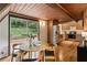 Charming eat-in kitchen boasts wood cabinets, stainless steel appliances, and sliding glass doors leading to the backyard at 3567 Beachhill Dr, Atlanta, GA 30340