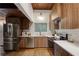 Contemporary kitchen with stainless steel appliances, wood cabinets, white counters, and herringbone backsplash at 3567 Beachhill Dr, Atlanta, GA 30340