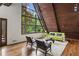 Bright living room with vaulted wood ceilings, hardwood floors, and a wall of windows offering stunning outdoor views at 3567 Beachhill Dr, Atlanta, GA 30340