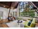 Spacious living room with a vaulted ceiling, hardwood floors, and large windows, seamlessly blending indoor and outdoor living at 3567 Beachhill Dr, Atlanta, GA 30340