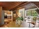 Open-concept living area seamlessly connects the kitchen and living room with vaulted wood ceilings and hardwood floors at 3567 Beachhill Dr, Atlanta, GA 30340