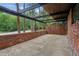 Covered patio with brick accent wall and concrete flooring perfect for entertaining at 3567 Beachhill Dr, Atlanta, GA 30340