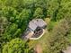 Aerial view of the home displaying the layout and a well-maintained yard nestled among lush trees at 588 Peachtree Se Dr, White, GA 30184