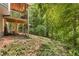 Exterior backyard showing an elevated back porch with yard and surrounding trees at 588 Peachtree Se Dr, White, GA 30184