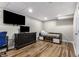 Finished basement featuring a television, carpet, and wood laminate flooring at 588 Peachtree Se Dr, White, GA 30184