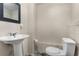 Compact bathroom featuring a pedestal sink and toilet with tiled flooring at 588 Peachtree Se Dr, White, GA 30184