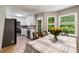 Bright dining area connects seamlessly to a white kitchen with stainless appliances and ample natural light at 588 Peachtree Se Dr, White, GA 30184