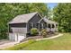This home features a side-entry garage and manicured landscaping, adding to its curb appeal in a neighborhood at 588 Peachtree Se Dr, White, GA 30184