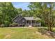 Charming single-story home with gray siding, a covered front porch, and attractive landscaping at 588 Peachtree Se Dr, White, GA 30184