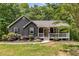 Charming single-story home with gray siding, a covered front porch, and attractive landscaping at 588 Peachtree Se Dr, White, GA 30184