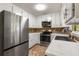 Well-lit kitchen featuring stainless steel appliances and white cabinets at 588 Peachtree Se Dr, White, GA 30184