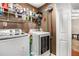 Functional laundry room with washer, dryer, shelving, and storage space at 588 Peachtree Se Dr, White, GA 30184