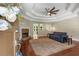 Inviting living room with a stone fireplace, tray ceiling, and seamless flow into the dining area at 588 Peachtree Se Dr, White, GA 30184