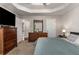 Bedroom featuring carpet, a ceiling fan, shiplap wall, and tray ceilings at 588 Peachtree Se Dr, White, GA 30184