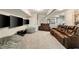 Finished basement with a full reclining leather sofa, movie screens, and comfy seating with plush ottomans at 690 Cobblestone Creek Ln, Mableton, GA 30126