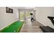 Versatile finished basement featuring a putting green, gym equipment, and an exterior door at 690 Cobblestone Creek Ln, Mableton, GA 30126