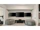 Basement entertainment area featuring mounted TVs and lounge seating at 690 Cobblestone Creek Ln, Mableton, GA 30126