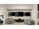 Basement entertainment area featuring three TVs, comfortable bean bag chairs, and a treadmill at 690 Cobblestone Creek Ln, Mableton, GA 30126