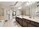 Bright Primary bathroom with double vanity, large mirrors, and a separate glass shower at 690 Cobblestone Creek Ln, Mableton, GA 30126