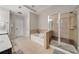 Bright bathroom with tile floor, bath and separate shower with clear glass door at 690 Cobblestone Creek Ln, Mableton, GA 30126