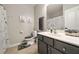 Neutrally decorated bathroom featuring vanity with grey cabinets, shower, and toilet at 690 Cobblestone Creek Ln, Mableton, GA 30126