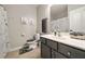Neutral bathroom features gray vanity with white countertop, framed mirror, and shower/tub with curtain at 690 Cobblestone Creek Ln, Mableton, GA 30126