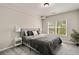 Bedroom with a large window offering natural light and neutral decor at 690 Cobblestone Creek Ln, Mableton, GA 30126