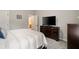 Bedroom featuring a large bed, dresser with a TV, and a view into the en suite at 690 Cobblestone Creek Ln, Mableton, GA 30126