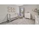 Cozy Bedroom with animal-themed decor, crib, rocker, and dresser at 690 Cobblestone Creek Ln, Mableton, GA 30126