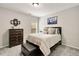Cozy bedroom with a queen-sized bed, dresser, ottoman and soothing gray carpet at 690 Cobblestone Creek Ln, Mableton, GA 30126