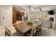 Open-concept dining area featuring a modern light fixture, dining table, and seamless flow into the living room and kitchen at 690 Cobblestone Creek Ln, Mableton, GA 30126