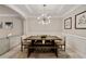 Dining room with modern lighting, wainscotting, and a table with seating for six at 690 Cobblestone Creek Ln, Mableton, GA 30126