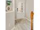 Bright foyer with a white door, light wood flooring, and a beautiful floral arrangement in a decorative vase at 690 Cobblestone Creek Ln, Mableton, GA 30126