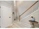 Foyer featuring soaring ceilings, light gray paint, wood floors, and a staircase at 690 Cobblestone Creek Ln, Mableton, GA 30126