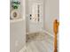 Bright foyer with white door, wood floors, and view to the stairs at 690 Cobblestone Creek Ln, Mableton, GA 30126