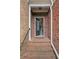 Covered brick entryway with black front door and sidelight at 690 Cobblestone Creek Ln, Mableton, GA 30126