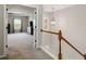 Bright hallway leading to a Primary bedroom featuring tray ceilings and plush carpet at 690 Cobblestone Creek Ln, Mableton, GA 30126